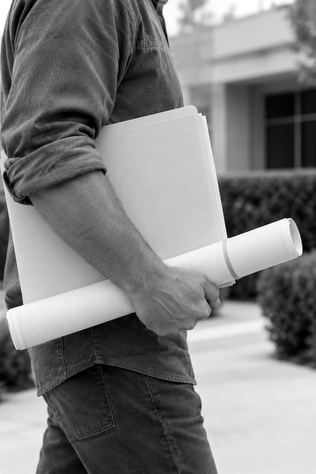 Render of a forearm carrying a plain folder and a rolled drawing, seen from the side.