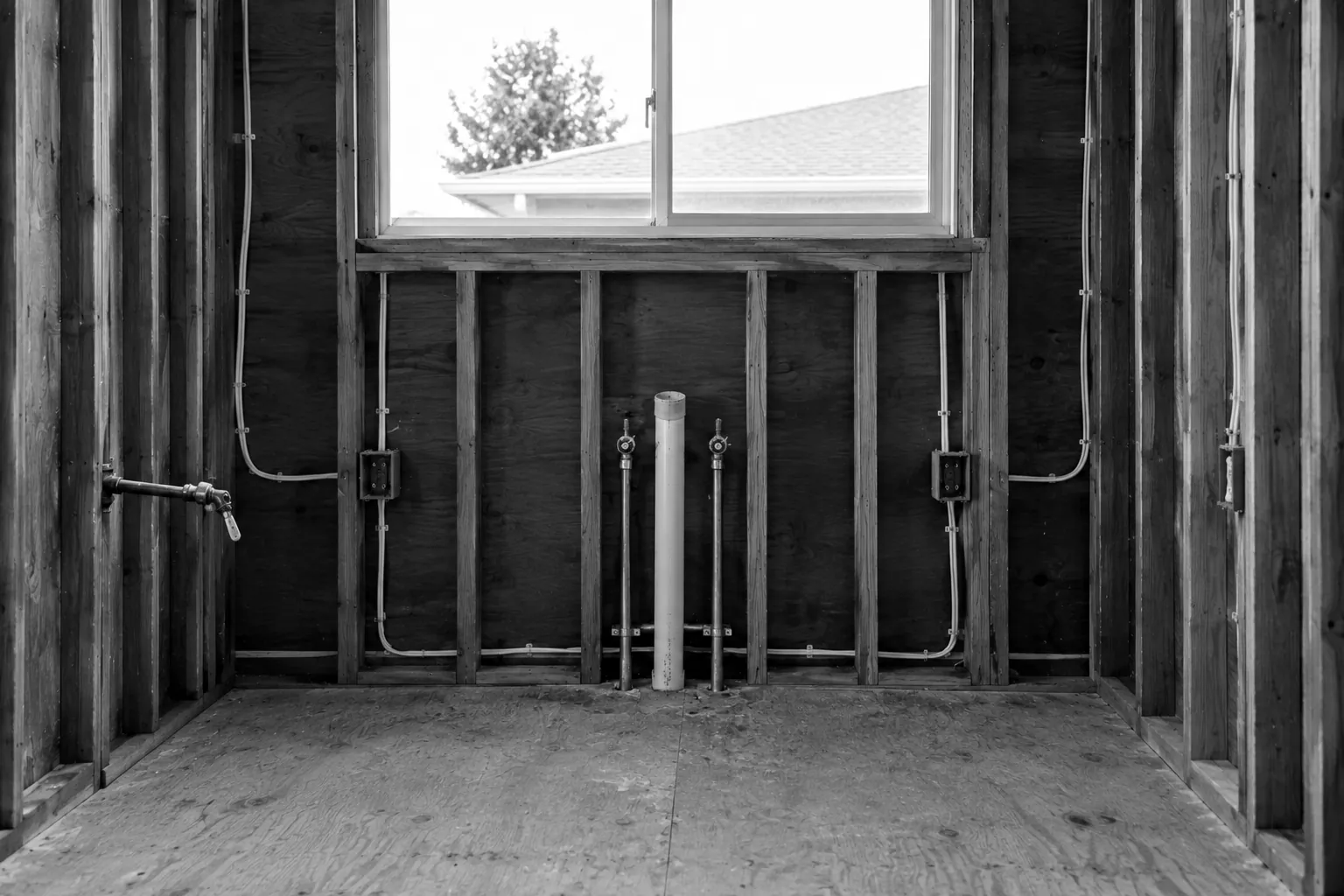 Render of an open kitchen wall at rough-in: new wiring and outlet boxes, copper water lines, a drain pipe and a gas valve, ready for inspection.